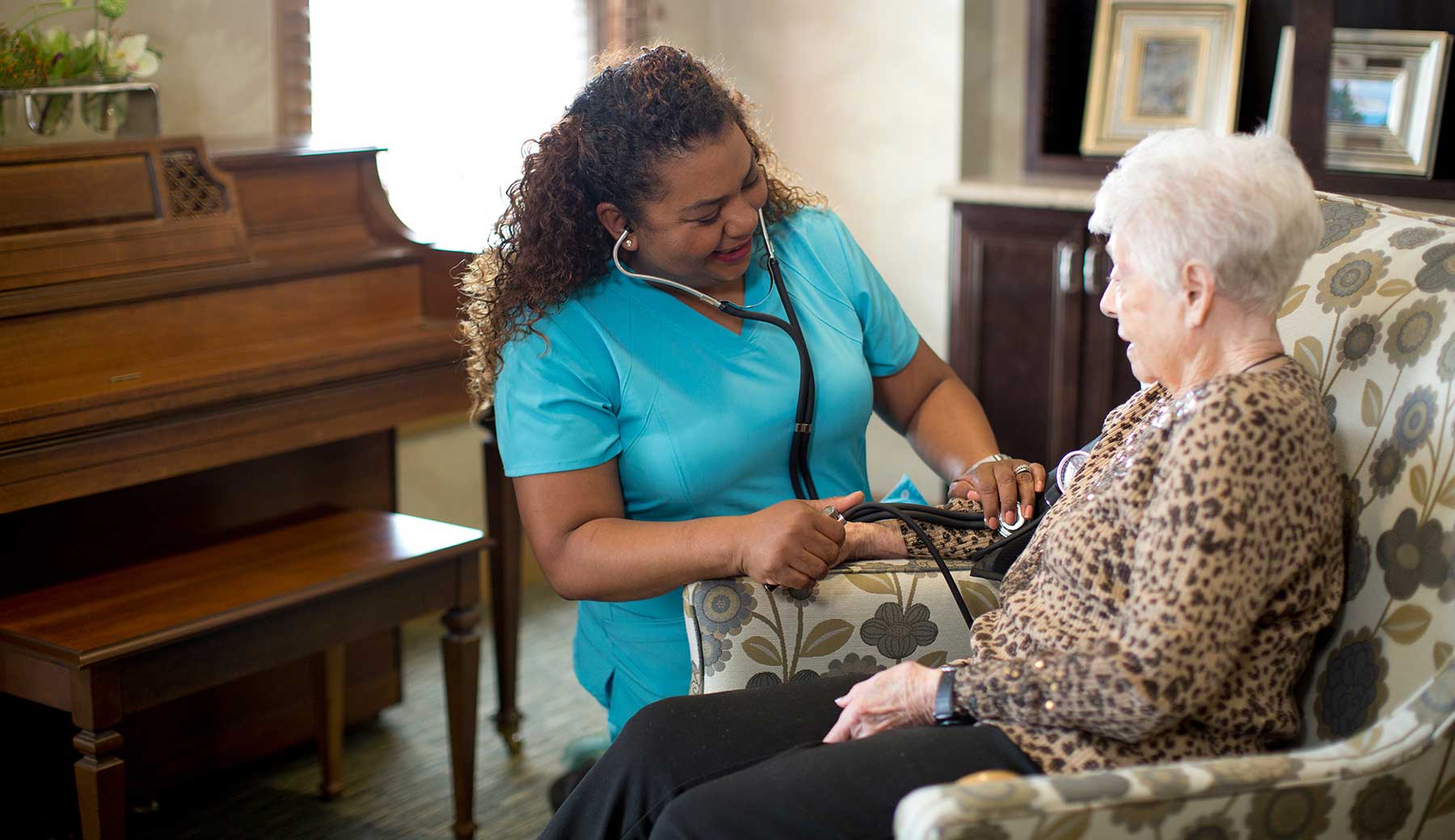 a nurse taking a patients blood pressure.